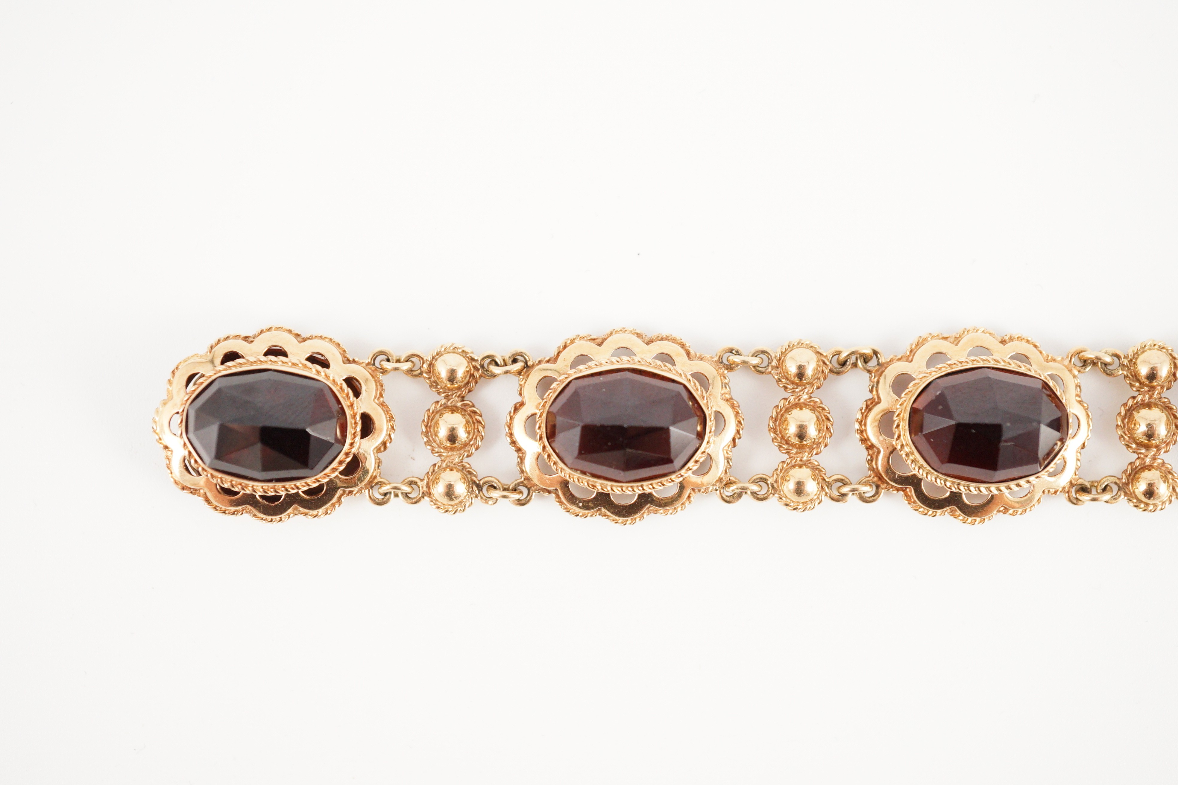 A 20th century Dutch 14k gold and six stone facet cut cabochon garnet set fancy link bracelet